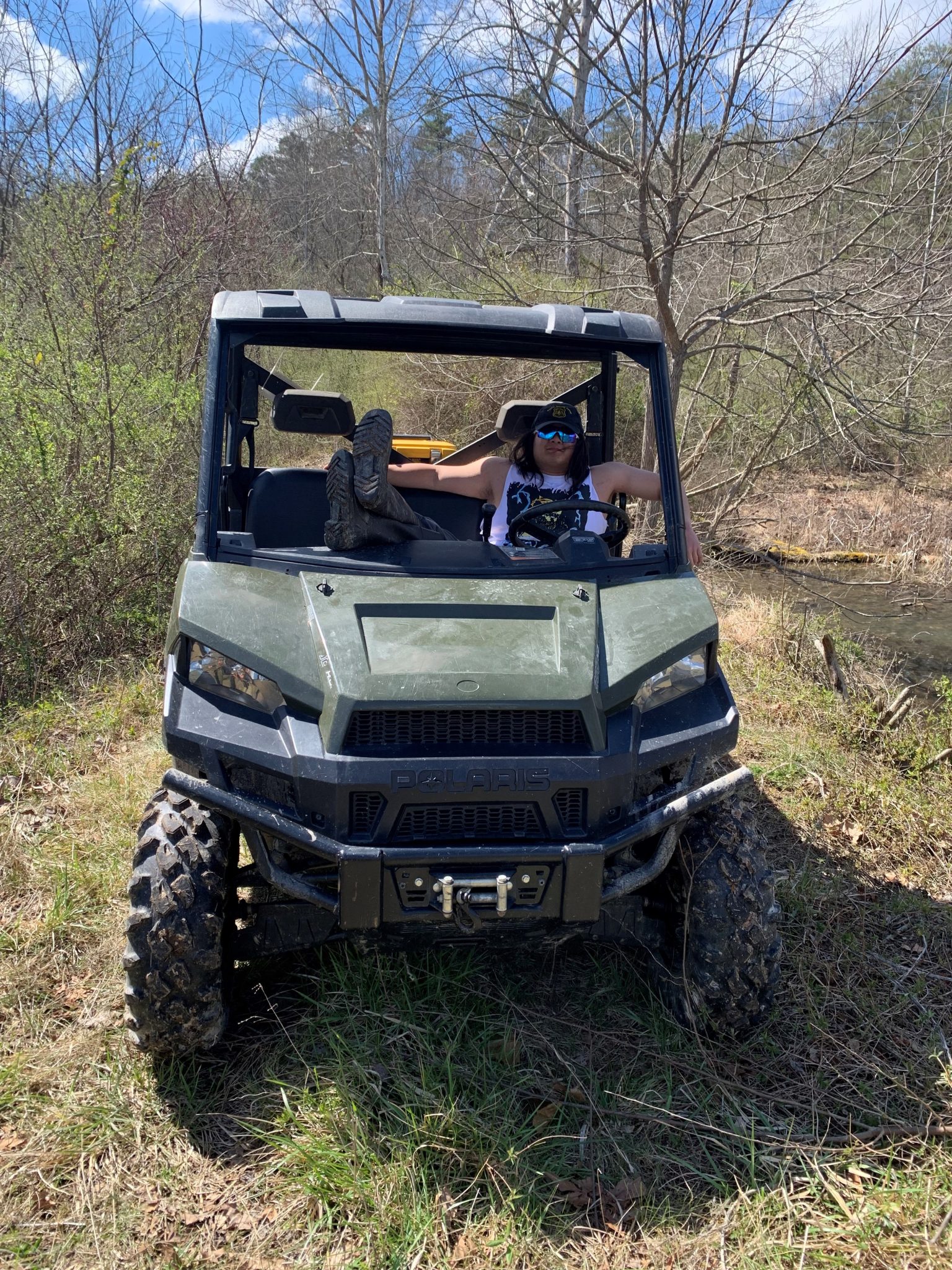 Young women in a four wheel jeep on a backcountry trail.