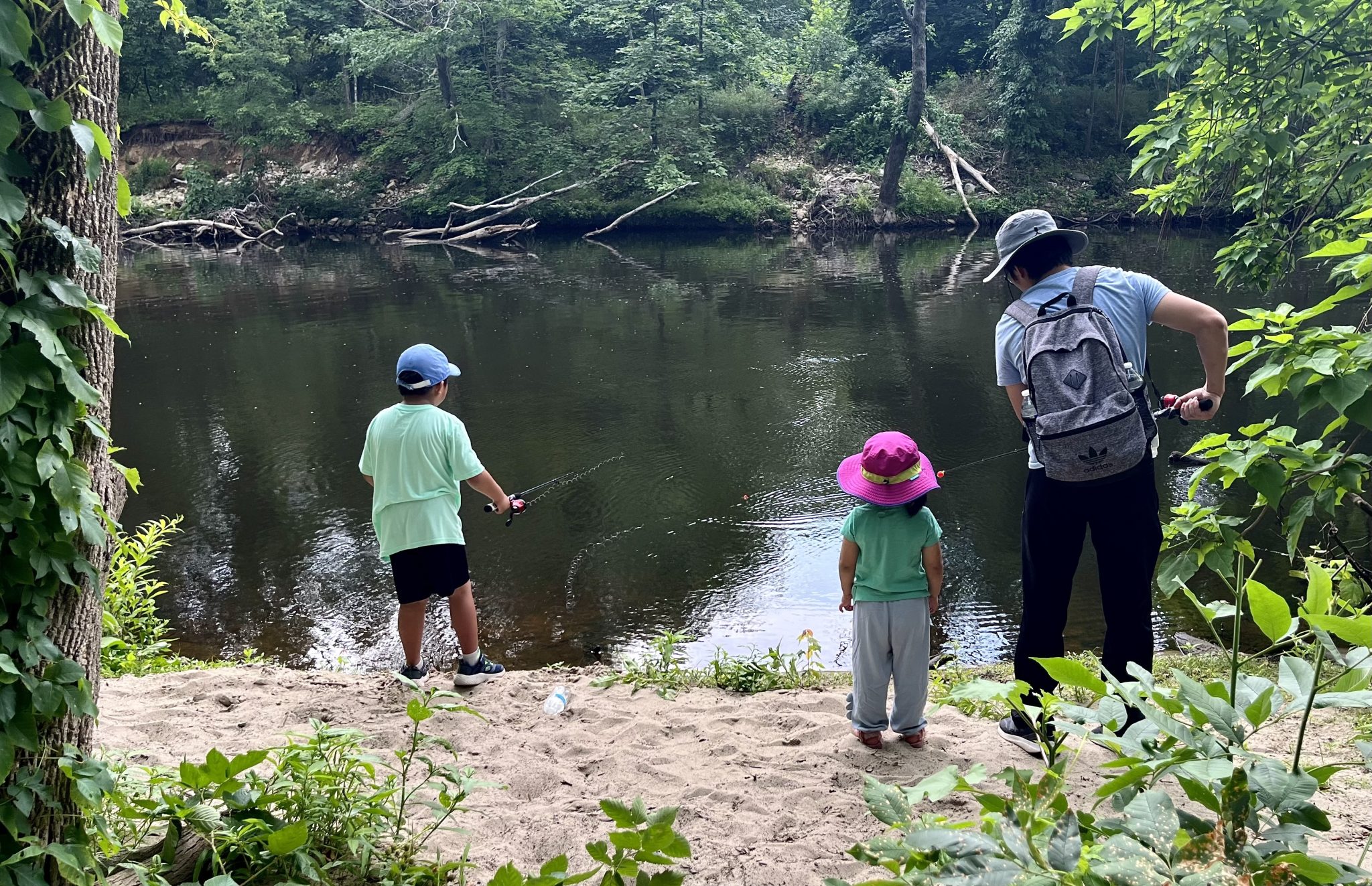 Family of three fishing along the sandy bank of the Blackstone River at Sycamore Landing, Lincoln, RI