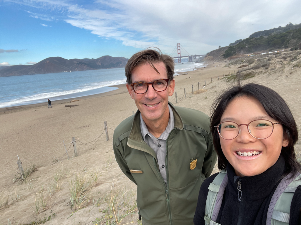Angelica Wu, winner of the Standout Communication Award at Golden Gate National Recreation Area, poses with her supervisor in front of the Golden Gate Bridge.