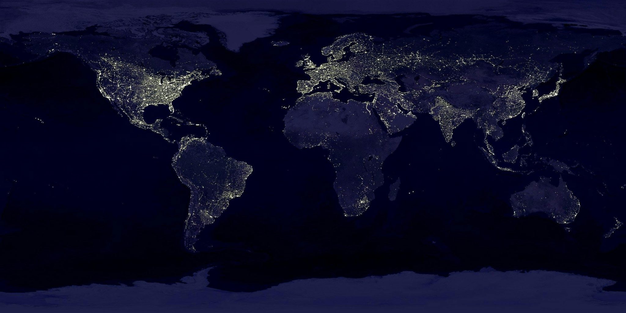 Dark blue map of the Earth at night, showing city lights and illuminated areas.