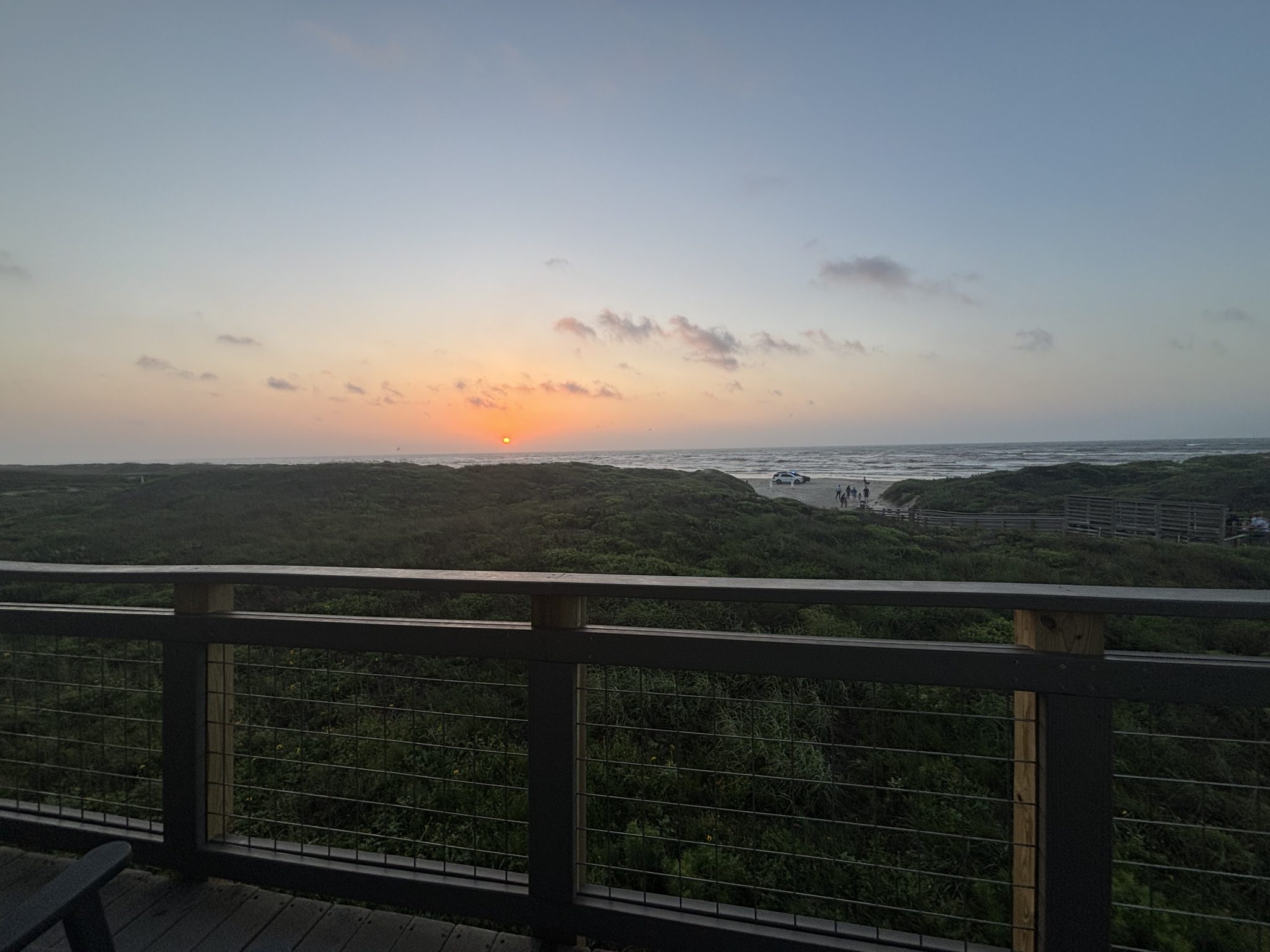 Photo of a sunrise at Padre Island National Seashore on deck of visitor center.