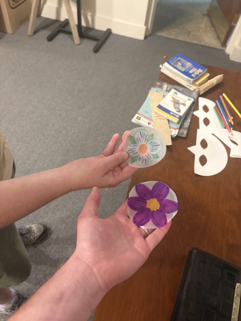 Zack and Amanda holding their example window clings.